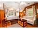 Bedroom featuring wood paneling, hardwood floors, a ceiling fan, and a sitting area at 2169 Westrivers Rd, Charleston, SC 29412
