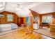 Bedroom showcasing wood paneling, hardwood floors, a ceiling fan, and bright natural light at 2169 Westrivers Rd, Charleston, SC 29412