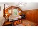 Bedroom featuring wood paneling, hardwood floors, a ceiling fan, and a sitting area at 2169 Westrivers Rd, Charleston, SC 29412