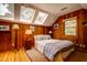 Bedroom with wood paneling, hardwood floors, a ceiling fan, and bright natural light at 2169 Westrivers Rd, Charleston, SC 29412