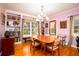 Elegant dining room with beautiful hardwood floors, built-in bookshelves, and a classic chandelier, offering a warm ambiance at 2169 Westrivers Rd, Charleston, SC 29412