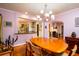 Spacious dining room featuring polished wood table with six chairs, offering a seamless transition to the modern kitchen at 2169 Westrivers Rd, Charleston, SC 29412