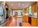 Modern kitchen featuring stainless steel appliances, custom cabinets, and seamless flow to living room at 2169 Westrivers Rd, Charleston, SC 29412