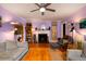 Cozy living room with a fireplace, ceiling fan, and wood floors at 2169 Westrivers Rd, Charleston, SC 29412