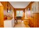 Room with wood paneling, hardwood floors, a large window, and a work table at 2169 Westrivers Rd, Charleston, SC 29412