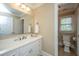 Bright bathroom with white vanity, modern fixtures, and an adjacent toilet room featuring a window at 225 River Oak Dr, Mount Pleasant, SC 29464