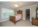 Bedroom with a carved wood bed, large window, and traditional furnishings at 225 River Oak Dr, Mount Pleasant, SC 29464