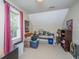 Attic bedroom with window, desk, and various storage containers at 225 River Oak Dr, Mount Pleasant, SC 29464