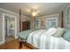 Bedroom featuring four-poster bed, ceiling fan, wood floors and ensuite bath at 225 River Oak Dr, Mount Pleasant, SC 29464