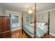 Bedroom featuring four-poster bed, ceiling fan and views of the landscaped yard at 225 River Oak Dr, Mount Pleasant, SC 29464