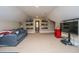 Spacious carpeted bedroom with a comfortable sitting area, TV, and wall shelving at 225 River Oak Dr, Mount Pleasant, SC 29464