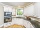 Well-lit kitchen showcases custom cabinets, granite counters, stainless appliances, and hardwood flooring at 225 River Oak Dr, Mount Pleasant, SC 29464