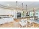 Bright kitchen features white cabinetry, barstool seating at the island, and stainless steel appliances at 225 River Oak Dr, Mount Pleasant, SC 29464