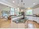Modern kitchen features an island, white cabinets, granite countertops, and a seamless connection to the living area at 225 River Oak Dr, Mount Pleasant, SC 29464
