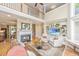 Elegant living room boasts fireplace, built-ins, wood floors, and open floorplan with lots of natural light at 225 River Oak Dr, Mount Pleasant, SC 29464