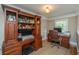 Home office with hardwood floors, wood trim, built-in shelving, and large window at 225 River Oak Dr, Mount Pleasant, SC 29464