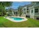Backyard pool area with lush landscaping, offering a serene and private outdoor retreat at 225 River Oak Dr, Mount Pleasant, SC 29464