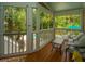 Screened-in porch overlooking a pool with outdoor seating surrounded by lush greenery at 225 River Oak Dr, Mount Pleasant, SC 29464