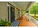Cozy front porch featuring rocking chairs, a decorative wreath, and a charming welcome mat at 225 River Oak Dr, Mount Pleasant, SC 29464