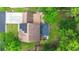Aerial view of the house with solar panels, a brick roof, mature trees and a large driveway at 2436 Stingray Blvd, North Charleston, SC 29406
