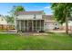 Wide-angle view of the back of the house with a screened in porch and nice lawn at 2436 Stingray Blvd, North Charleston, SC 29406
