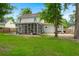 View of the back of the house, featuring a screened in porch and well maintained lawn at 2436 Stingray Blvd, North Charleston, SC 29406