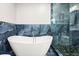 Elegant bathroom featuring large soaking tub and marble-look tile surround at 2436 Stingray Blvd, North Charleston, SC 29406