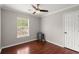 Cozy bedroom featuring hardwood floors, a ceiling fan, and a bright window at 2436 Stingray Blvd, North Charleston, SC 29406