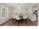 Charming dining room with hardwood floors, light fixture, and window provides plenty of natural light and space at 2436 Stingray Blvd, North Charleston, SC 29406