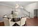 Well-appointed dining area with hardwood floors, glass-top table, and a chandelier adds simple elegance to the room at 2436 Stingray Blvd, North Charleston, SC 29406