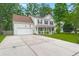 Charming two-story home featuring a two-car garage, inviting front porch, and a well-manicured front yard at 2436 Stingray Blvd, North Charleston, SC 29406