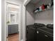 Functional laundry area includes a washer, dryer, and shelving for storage at 2436 Stingray Blvd, North Charleston, SC 29406