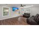 Bright living room features hardwood floors and large windows that bring the outdoors inside for an airy feeling at 2436 Stingray Blvd, North Charleston, SC 29406