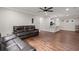 Open concept living room boasts hardwood floors, ceiling fan, and neutral paint scheme for a clean, modern look at 2436 Stingray Blvd, North Charleston, SC 29406