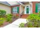 Charming brick home entrance featuring a well maintained landscaped yard, brick steps and a green front door at 2520 Woodstream Rd, Mount Pleasant, SC 29466