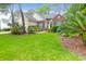 Beautifully landscaped front yard showcasing a well maintained lawn and a charming home with green shutters at 2520 Woodstream Rd, Mount Pleasant, SC 29466