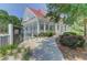 Community pool house with a white facade, a red roof, and a wraparound porch for residents at 2520 Woodstream Rd, Mount Pleasant, SC 29466