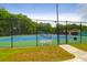 Community tennis courts featuring a blue and green surface and a sturdy fence in a lush setting at 2520 Woodstream Rd, Mount Pleasant, SC 29466