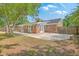 Backyard featuring a brick house, wood fence, green trees, and a concrete patio at 2534 Flamingo Dr, Charleston, SC 29414