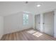 Bright bedroom featuring wood floors, white walls, natural light from a window, and closets at 2534 Flamingo Dr, Charleston, SC 29414