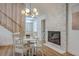 Dining area features an accent wall fireplace and wood floors at 2534 Flamingo Dr, Charleston, SC 29414