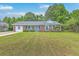 Charming brick home featuring a well-manicured lawn and inviting front porch with light blue shutters and a matching front door at 2534 Flamingo Dr, Charleston, SC 29414