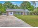 Attractive brick home with light blue shutters and front door, complemented by green landscaping and a driveway at 2534 Flamingo Dr, Charleston, SC 29414