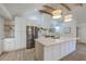 Modern kitchen featuring a large island, stainless steel appliances, open shelves and white cabinets at 2534 Flamingo Dr, Charleston, SC 29414