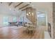 Open-concept living and dining area with hardwood floors, high ceilings, and a cozy seating arrangement at 2534 Flamingo Dr, Charleston, SC 29414