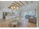 Open-concept living space featuring wood floors, wood beam vaulted ceilings, a dining area, and a comfortable seating area at 2534 Flamingo Dr, Charleston, SC 29414