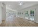 Bright living room showcasing hardwood floors, white walls, ceiling fans and large windows at 2534 Flamingo Dr, Charleston, SC 29414