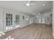 Bright living room showcasing hardwood floors, white walls, ceiling fans and large windows at 2534 Flamingo Dr, Charleston, SC 29414