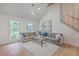 Cozy living room with vaulted ceilings, a ceiling fan, plush carpet, and large windows offering natural light at 2534 Flamingo Dr, Charleston, SC 29414