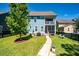 Inviting backyard with lush green grass, a walkway, fenced yard, and a patio with a screened-in porch above at 2627 Rutherford Way, Charleston, SC 29414